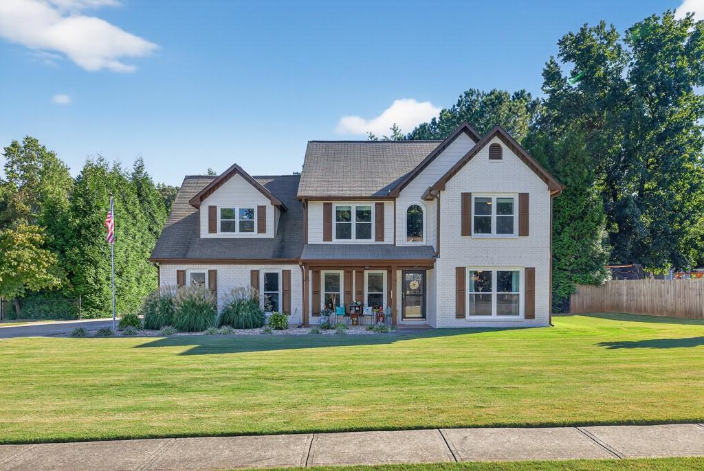 Welcome to your private Buford retreat in the sought after Seckinger school district. This spacious four bedroom two and a half bath home has been thoughtfully updated and meticulously maintained, offering the perfect blend of comfort, privacy, and convenience. The home features a newly painted exterior, upgraded UV tinted windows, and cordless blinds throughout most of the house. The kitchen has been refreshed with new granite countertops, freshly painted cabinets, a new oven range, and a new microwave. Upstairs you will find added floor space above the foyer, a large master suite with an upgraded granite vanity, customized walk in closet, and a beautifully improved shower. All bathrooms feature added storage above the toilets and the fourth bedroom has an upgraded closet for extra functionality. The home is equipped with a dual zone HVAC system with dampeners for comfort year round. Outside, enjoy a beautifully landscaped low maintenance lawn with irrigation, a very large driveway, and an expanded patio that stretches the length of the house, perfect for entertaining. The backyard is a rare sanctuary featuring a permaculture layout, chicken coop, two sheds, and permanent green space that will never be developed, providing unmatched privacy with mature trees that create a natural retreat. This type of setting is extremely hard to find with the way neighborhoods are developed today. With no HOA and a location that places you close to top schools, shopping, and dining, this property offers both convenience and tranquility. Combining thoughtful upgrades with a private natural backdrop, this home is ready for its next owner to enjoy for years to come!