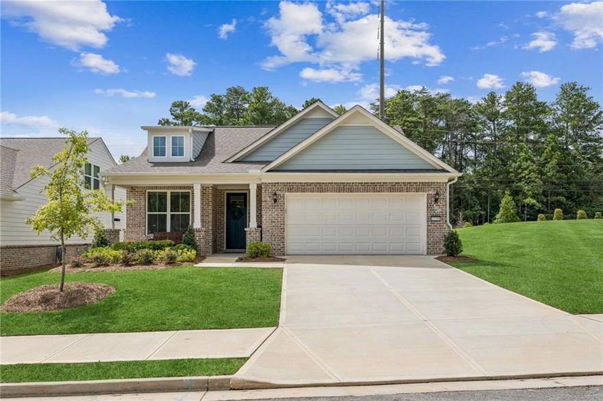 Ready to downsize? This like-new ranch built in 2024 in Buford offers one-level living in a location that can’t be beat—just a short walk to Lake Lanier parks and walking trails, 10 minutes to downtown Buford and Sugar Hill, and 15 minutes to Suwanee or Cumming. Close to all the shopping and dining you could want at the Cumming Marketplace, yet tucked away in a peaceful, country-like setting. Pulte’s popular mainstay floor plan features an open layout with kitchen, dining, and living spaces together, plus a front office overlooking the street. The patio and walkout backyard provide space for grilling or gardening. Inside, updates include crown molding, an oversized quartz island, neutral flooring, 5" baseboards, soft-close drawers, walk-in pantry, and a contemporary hooded vent over the cooktop. The spacious primary suite is a true retreat, featuring a large walk-in closet and a luxurious bathroom with an oversized frameless glass shower enclosure and custom tile. Bright and move-in ready, this home is part of Lakecrest, a 55+ community that include landscaping—perfect for those who want low-maintenance living without paying for extra amenities they won’t use.