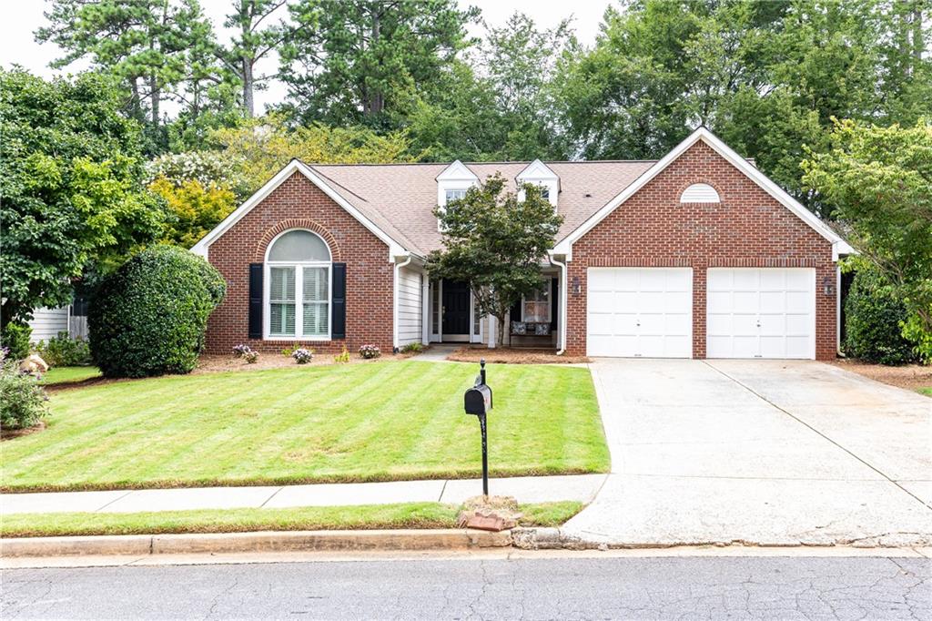 Welcome to ONE-LEVEL living in Spencer’s Mill, one of East Cobb’s most desirable swim/tennis communities. This charming Ranch home features 3 bedrooms plus a flexible bonus room with closet—perfect as a 4th bedroom, currently being used as an office. The open-concept layout is filled with natural light, enhanced by vaulted ceilings, fresh paint, and brand-new LVP flooring throughout.  The kitchen offers white cabinetry, stone countertops, pantry and a spacious breakfast area. The large dining room and great room overlook the oversized fenced backyard—ideal for entertaining or relaxing. A cozy fireplace anchors the great room, adding warmth and charm, while the adjacent sunroom provides a peaceful spot for morning coffee or quiet evenings. The sunroom leads out to a deck where you can enjoy built-in seating and space for your grill. The private primary suite is thoughtfully separated from the guest wing, which includes two additional bedrooms and a full bath. A two-car garage connects to a dedicated laundry room for added convenience. Enjoy the neighborhood's resort-style amenities including a pool, tennis/pickleball courts, playground, and more—all just steps away. Conveniently located near top-rated East Cobb schools, shopping, and dining, this rare one-level home is ready for you to make it your own.