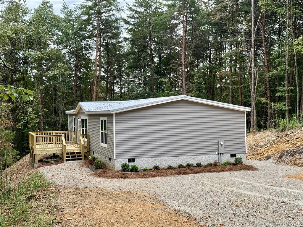 Brand new 3 bedroom, 2 bath mobile home with many upgrades. Starting on the exterior, this home has a metal roof for years of maintenance free living. Inside are many nice features: stainless steel appliances, farmhouse sink, upgraded shaker cabinets, recessed lighting throughout, ceiling fan in the living room, double sinks in the master bath with a large walk in shower and window blinds already installed. This home is ready to go. The open floorplan provides lots of room for the family room, dining room and kitchen. The master bedroom is generous with a large master bath and separate tub and shower. There is also a walk in closet. The split floor plan has 2 additional bedrooms with walk in closets. The front deck is oversized at 12x18 for your outdoor living. This wooded 2 acres will provide plenty of privacy with about a 20 minute drive to Jasper.
