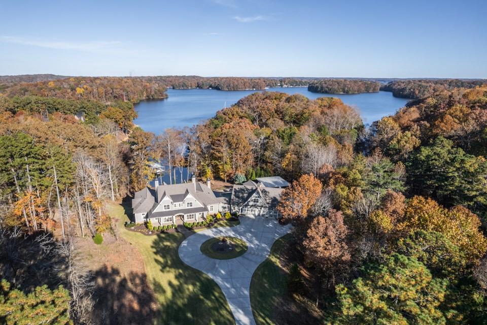 Beautiful Luxury estate located waterfront on Lake Lanier! Sitting on 3.7 acres, an extravagant property that includes 7 bedrooms with master on the main floor, spacious guest apartment, chef’s kitchen w/ Thermador appliances, secondary butler’s kitchen, elegantly finished terrace, refreshing saltwater pool w/ covered living spaces, basketball court, and even RV parking! This custom lake home boasts exceptional lake views from almost every room in the house. Gentle sloped path from the home to the dock, deep water, 2 slip covered dock.