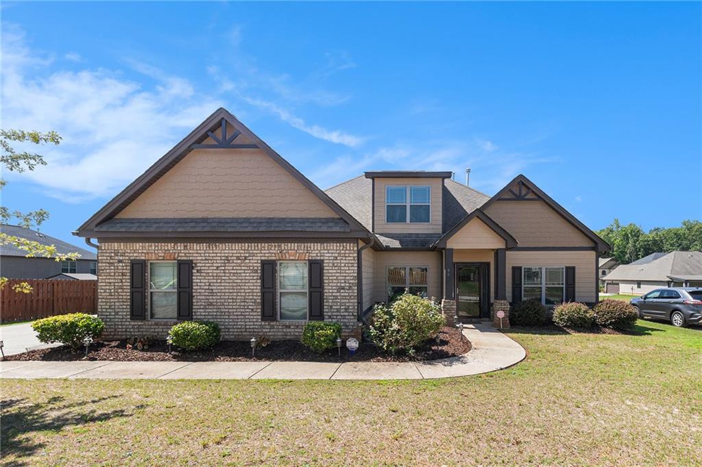Step into your dream retreat with this stunning ranch-style abode, nestled in serene Covington, GA, just off I-20. This charming residence's main level boasts three generous bedrooms and two full bathrooms, offering great convenience. Soaring ceilings and rich hardwood floors grace the common areas and master suite, exuding warmth and elegance. The master bedroom is a true sanctuary, complete with two spacious closets, while its en-suite bathroom features a luxurious soaking tub, a separate shower, and a stylish double vanity. The expansive kitchen seamlessly flows into the inviting family room, where a picturesque stone fireplace beckons you to gather. Upstairs, a grand fourth bedroom with an ensuite bathroom awaits, offering endless possibilities—think game room, media haven, or inspiring office space. This remarkable home is brimming with potential and ready to become your personal paradise!