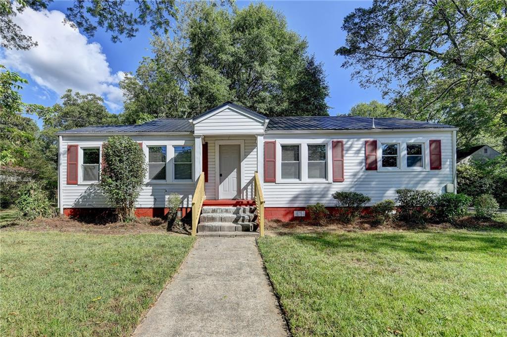 Your Perfect Blend of Character & Convenience! Step into this charming 2-bedroom, 1-bath gem (with bonus room!) offering 1,250?sq?ft of cozy living space in the heart of Winder. Built in 1965 and lovingly updated, this home blends timeless charm with modern amenities. Hardwood Floors Throughout — Real original hardwoods paired with freshly resurfaced floors add warmth and elegance in every room. Versatile Bonus Room that you can make very cozy den, home office, or third bedroom—the choice is yours! The stone fireplace adds a nice focal point in the living room, it’s perfect for chilly Georgia nights and intimate gatherings.
Sleek and durable granite countertops which elevates the kitchen with a refined, high-end feel. Long-lasting and energy-efficient metal roof adds peace of mind and style. Ample parking wraps all around the home, ideal for family vehicles, guests, or even a boat or RV. Perfectly situated in vibrant Winder, walk or drive to downtown shops, quaint cafés, and community events. Fort Yargo State Park and local greenways are just minutes away for those who love outdoor adventures. Schedule your private showing today and see firsthand why this one is the perfect place to call home!