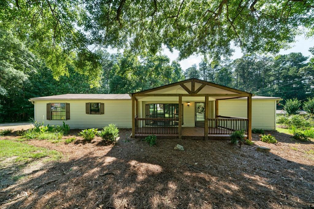 Charming and spacious, UPDATED, MOVE-IN READY 3-bedroom, 2-bath double wide mobile home on a permanent foundation is ready for YOU! (Yes, the titles have been retired!!) The home is located on a beautiful, usable, flat 1.01-acre lot in desirable East Paulding. This home features a spacious, roommate-style floor plan for privacy, with brand-new carpet and paint in the bedrooms. The large kitchen offers stainless steel appliances, including a GAS STOVE, and ample cabinet and counter space. The open-concept dining area overlooks the living room as well as the kitchen. Both bathrooms are completely remodeled with luxury vinyl tile, new vanities, mirrors, tub or shower, and lighting. Enjoy outdoor living with a 200 sq ft covered front porch, a 480 sq ft covered back deck, plus a 120 sq ft attached storage room and detached shed. This home has it all, affordable price, condition, location, and has convenient access to everything! Schedule your tour today!!
