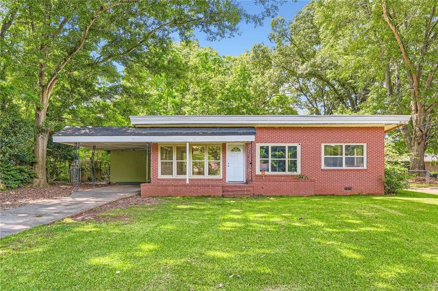 READY TO MOVE IN & READY FOR HOMEOWNERSHIP - Tucked just minutes from Hwy 41, Old Atlanta Rd, and the heart of shopping and dining, this charming one-level brick ranch offers a cozy retreat with timeless appeal. Step inside to find warm wood floors in the living room, setting the tone for comfortable everyday living. The kitchen provides space for daily routines, including washer and dryer connections for added ease. With three well-sized bedrooms and a full bath featuring a tub/shower combo, the home balances simplicity and practicality. Outside, a spacious backyard invites outdoor enjoyment, while the one-car carport adds convenience. Whether you’re starting fresh or scaling down, this home offers a solid foundation in a well-connected location. Discounted rate options and no lender fee future refinancing may be available for qualified buyers of this home.