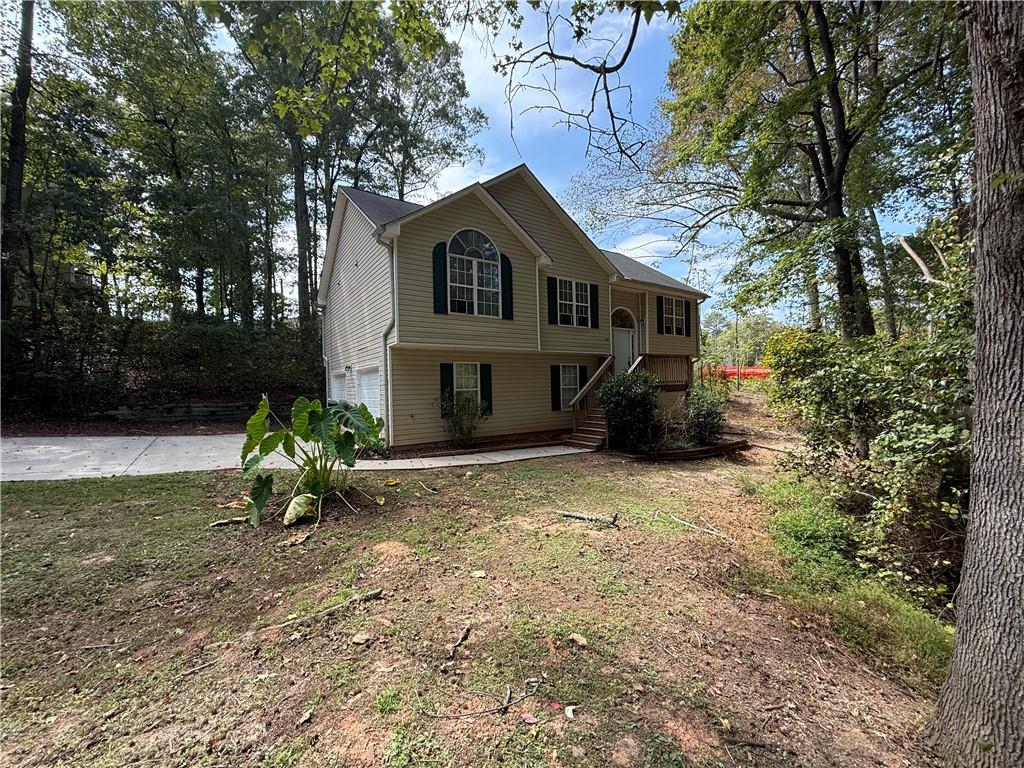 Located in the desirable Eagles Crest neighborhood just off I-675, this stunning home offers a private setting and is truly move-in ready. Inside, you’ll love the spacious 4-bedroom, 2-bath layout, perfect for families or anyone needing extra space. The kitchen is a chef’s dream with granite countertops, stainless steel appliances, and ample cabinet space. The main living areas feature beautiful hardwood floors, while bedrooms are finished with plush carpet for comfort. A gorgeous fireplace with ornate woodwork and built-in mirror serves as the focal point of the living room. The lower level includes a massive guest suite or media room with a cathedral ceiling and ceramic tile flooring, plus an additional unfinished room ideal for an office, gym, or storage. Throughout the home, vaulted and cathedral ceilings create an open and airy feel you’ll love. Don’t miss this opportunity to own a home that combines elegance, space, and privacy in a fantastic location!