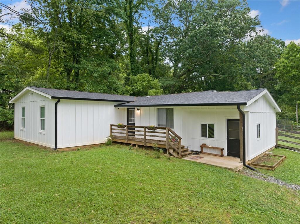 TOO CUTE TO PASS UP! RENOVATED BEAUTY ON OVER AN ACRE IN SOUGHT AFTER CREEKVIEW HIGH SCHOOL DISTRICT!! Welcome to your dream home in charming Ball Ground! This fully renovated gem in 2021 sits on a spacious 1+ acre lot and offers the perfect blend of modern updates and cozy charm. Every inch of this 3-bedroom, 2-bathroom home has been meticulously updated, including a new roof, gutters, HVAC, plumbing, electrical, insulation, and a brand-new water heater. Step inside to find an open, airy floor plan filled with natural light, all-new flooring, and a stunning Hardi board and batten exterior. The interior boasts neutral paint, a bright kitchen with new countertops, appliances, and upgraded fixtures. Just off the family room, you’ll find a bonus room, perfect for a home office, playroom, or media space. The spacious primary suite features double vanities and a sleek walk-in shower, while the second bathroom includes a tub/shower combo and private access from one of the secondary bedrooms; a rare and thoughtful touch that adds convenience and privacy for guests or family members. Enjoy peace of mind with a fenced in backyard and plenty of room to roam outside. Located in the highly desired Creekview High School district, this adorable home has it all; style, space, and updates galore. SELLER IS MOTIVATED TO RECEIVE OFFERS! Don’t miss your chance to make it yours—schedule your showing today!