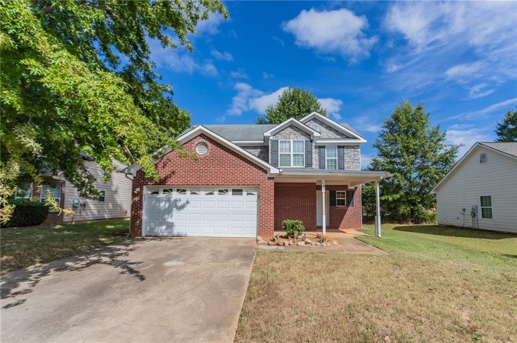 This 2-story home features 3 bedrooms, 2.5 bathrooms, a 2-car garage, and a charming front porch. Inside, you'll find a spacious living room with a cozy fireplace and a primary bathroom with a double vanity, separate tub, and shower. Please note: the home requires significant rehab—flooring has been removed down to the slab, some walls and ceilings are exposed to the wood framing. Toilets are not connected to water supply. This property presents a great opportunity for renovation or investment, offering the chance to fully customize and restore the home to your taste. Schedule your showing today and explore the potential!