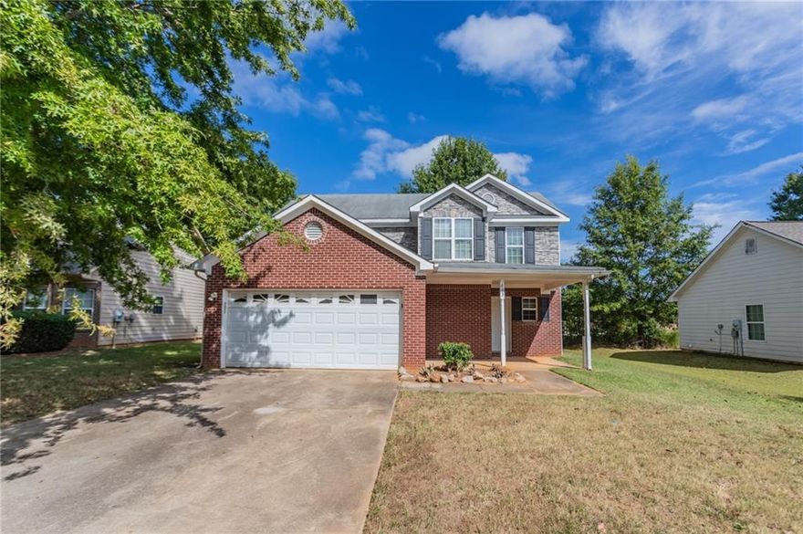 This 2-story home features 3 bedrooms, 2.5 bathrooms, a 2-car garage, and a charming front porch. Inside, you'll find a spacious living room with a cozy fireplace and a primary bathroom with a double vanity, separate tub, and shower. Please note: the home requires significant rehab—flooring has been removed down to the slab, some walls and ceilings are exposed to the wood framing. Toilets are not connected to water supply. This property presents a great opportunity for renovation or investment, offering the chance to fully customize and restore the home to your taste. Schedule your showing today and explore the potential!