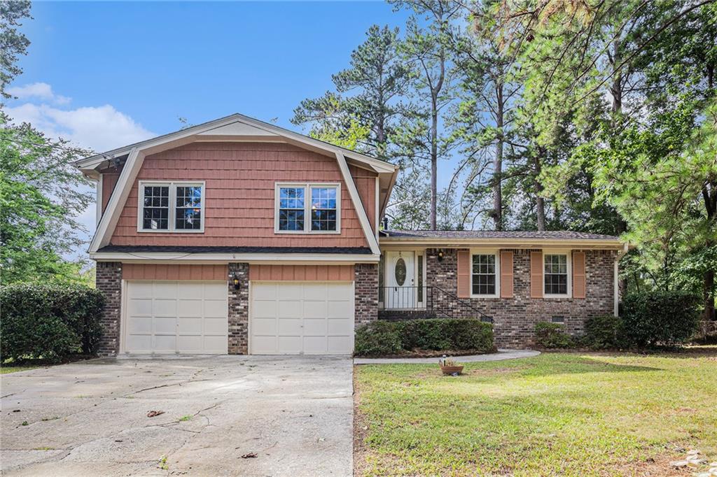 Opportunity Awaits in the Mountain Park/Trickum/Parkview School Area! This 3-bedroom, 2-bath split-level home is full of potential and nestled on a quiet street with no HOA. Featuring a classic 4-side brick and siding exterior, this home offers a spacious backyard, patio area, and a basketball goal setup — perfect for outdoor enjoyment. Inside, the home retains its original charm with no carpet in sight and is ready for your personal updates and vision. A great chance to customize a solid home in a sought-after location!