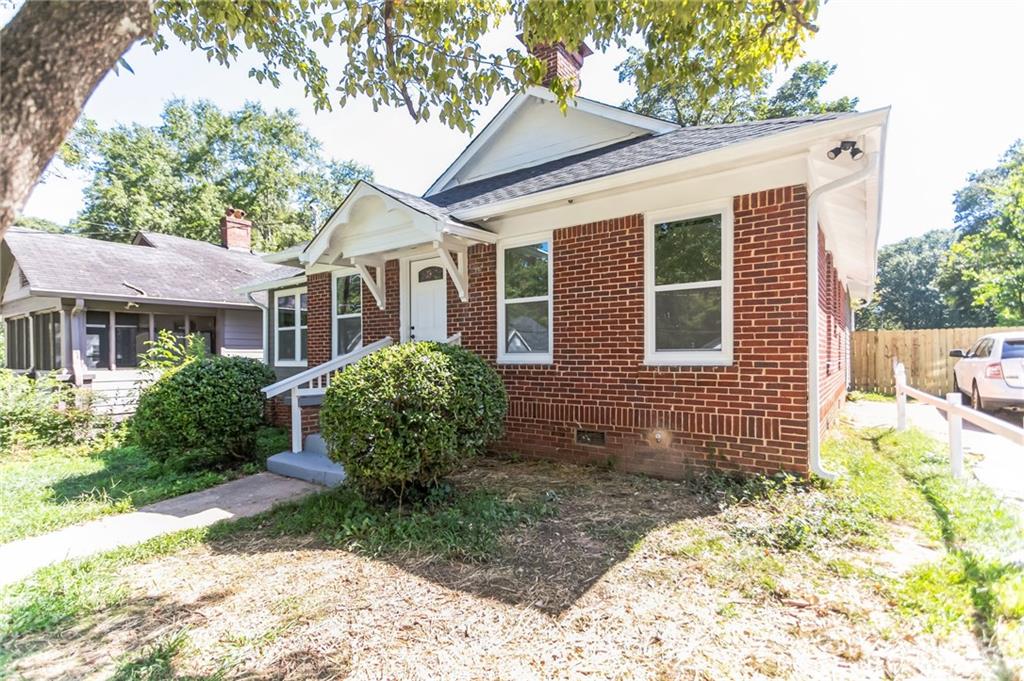 Welcome home to this renovated home conveniently located near Morehouse College, near Mercedes Benz Stadium, and minutes from the highway. Only a single tenant lived here before, the space is still practically new. This home consists of an all-new HVAC unit, plumbing, electrical wiring, appliances (washer / dryer, dishwasher etc.), flooring, windows, and a fresh coat of paint. Walk into a fully the open layout living room and updated kitchen with stainless steel appliances (including washer and dryer), quartz countertops. The home features classic components of the previous home's character with a dual wood-burning fireplace. Throughout the home, you'll notice sleek neutral and warm fixtures that add a modern finish to the home. The spacious rooms with new windows allow for great natural lighting to come in all around the home. The master bedroom has a giant walk in closet and spacious bathroom with a large shower. All bathrooms have been beautifully tiled adding an elegant touch to both. Make your way to the backyard and you'll find yourself on a spaciously built deck and a view of the large fenced-in backyard. Property has security system running, please call before touring!