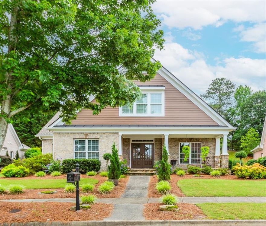 Welcome to The Preserve at Hamilton Mill! This beautiful 3 bedroom, 2.5 bath home features 4 sides brick and a charming covered front porch. Enjoy the convenience of a private rear-entry two-car garage and a low-maintenance lifestyle HOA includes lawn care. The main level offers tons of windows for natural light, a grand two-story foyer, beautiful hardwood/iron steps leading to second level, hardwoods throughout, an oversized master suite, and a laundry room spacious enough for a full-size refrigerator. The kitchen is equipped with stainless steel appliances, double ovens, a new dishwasher, and a new disposal, and it opens to a bright breakfast area and an expansive great room. Relax year-round on the covered screened rear porch, overlooking a beautifully landscaped yard requiring no upkeep. Roof and energy-efficient HVAC replaced in 2020. Upstairs, two generously sized secondary bedrooms feature walk-in closets and individual vanities with a shared tub/shower. Custom build-ins in loft area between the two bedrooms. Walk in attic space ready to be finished. Extra insulation recently added to attic making home extremely efficient for utility bills. Don't miss this well-maintained gem in a sought-after community! Just minutes to I-85 and 985.