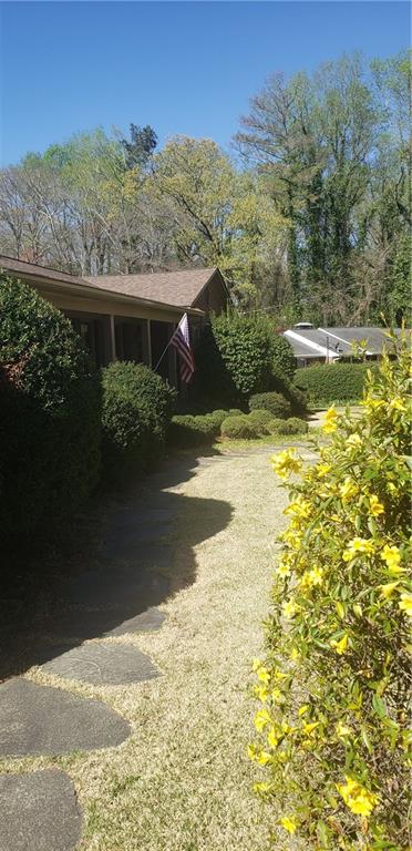 || RARE 4-SIDE BRICK RANCH || || FINISHED BASEMENT WITH MORE ROOM TO GROWN || || 2.3 PRIVATE ACRES - NO ONE CAN BUILD BEHIND YOU || || WALK TO EAST VALLEY ELEMENTARY & WHEELER HIGH || || NO HOA & NO RENT RESTRICTIONS || ** What You'll See ** The home sits on a LEVEL, LANDSCAPED LOT with 2.3 PRIVATE ACRES, backing up to permanent green space. Out back, the wide-open yard is alive with hummingbirds and the occasional deer no fences, no neighbors behind, just open sky and trees. The classic 4-SIDE BRICK construction gives the home a solid, grounded look that stands out in a well-kept, established neighborhood. ** What You'll Hear ** Step outside and you'll hear nature instead of traffic just birdsong and the wind moving through trees. Inside, enjoy the quiet crackle from either of the two FIREPLACES ON MAIN AND BASEMENT LEVELS, adding warmth and comfort without noise from nearby homes or roads. ** What You'll Feel ** With the MASTER ON MAIN and spacious rooms throughout, the layout is practical and comfortable. The FINISHED BASEMENT offers extra space without feeling disconnected great for entertaining, work, or guests. There is also unfinished space to create and grow! There's a calm, open feel throughout the home and property that gives you breathing room, inside and out. ** What You'll Experience ** Live without restrictions NO HOA & NO RENTAL LIMITS means full freedom to make this property fit your lifestyle or investment goals. And with WALKING DISTANCE TO TOP-RATED SCHOOLS like East Valley Elementary and Wheeler High, you get daily convenience in a location just minutes to I-75, with room to grow and space to live.