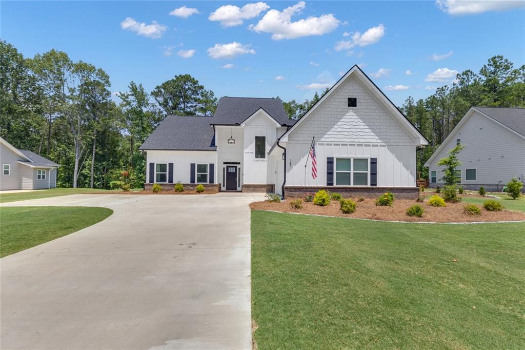 Lakefront luxury awaits at 147 Wolf Creek Cove in The Retreat on West Point Lake! Equipped with a deeded boat slip, this property is a dream come true for lake enthusiasts seeking year-round access to water activities and serene views. From the moment you arrive, you’ll be captivated by the timeless design, grand entrance, and meticulous landscaping that frames the property. Inside, discover expansive living spaces filled with natural light, soaring ceilings, and upscale finishes throughout—perfectly curated for both entertaining and everyday luxury. The gourmet kitchen is a chef’s dream, featuring high-end appliances, custom cabinetry, and stunning views. The primary suite is a private sanctuary with spa-like amenities, while additional bedrooms provide space and comfort for family and guests alike. Enjoy nature from your large screened-in porch, ideal for relaxing or entertaining. The Retreat is an upscale and private lake home community featuring gated entrances, scenic walking trails, and dedicated storage area for all your recreational needs. Whether you’re searching for a full-time residence or a weekend escape, this home offers the perfect blend of privacy, convenience, and lakefront living just minutes from downtown LaGrange. Live the lake life you’ve been dreaming of—schedule your private tour today!