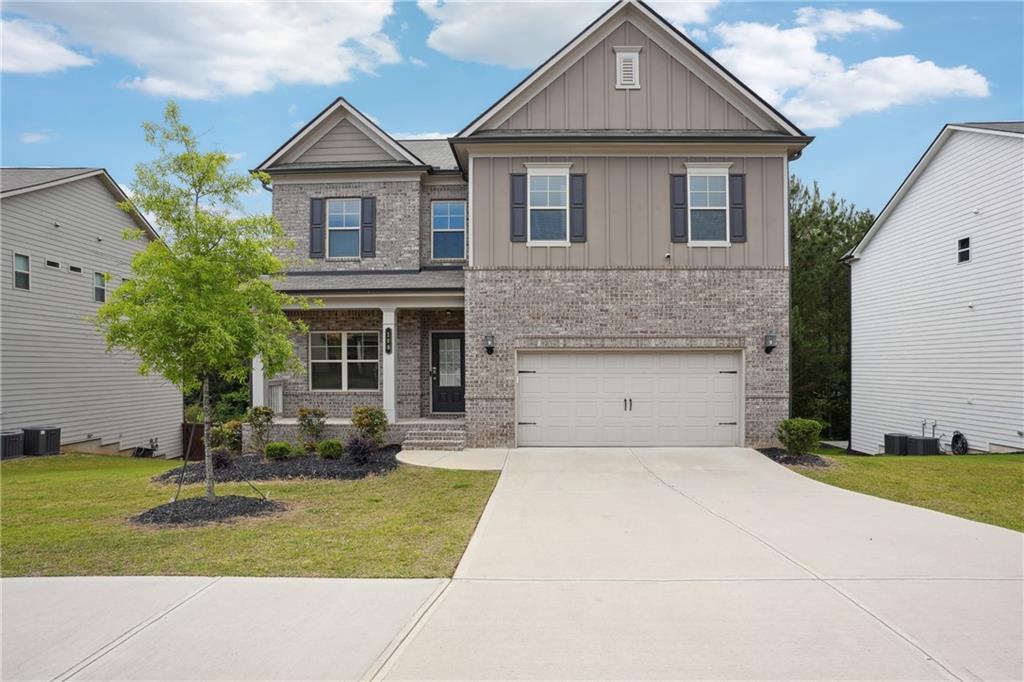Welcome Home to 106 Logan Pass Dr, Loganville, GA! Modern Design, Spacious Living & Private Backyard with Full Unfinished Basement Potential! This stunning 2-story residence offers a perfect blend of contemporary design, expansive living, and comfortable elegance, ideally situated in a desirable Loganville neighborhood. This home also features a full, unfinished basement, providing incredible potential for future expansion, whether you envision a media room, home gym, or additional living space tailored to your needs. The heart of the home is a well-appointed kitchen featuring rich, dark wood cabinetry, gleaming dark granite countertops, and a stylish tile backsplash. It's fully equipped with stainless steel appliances, including a range, built-in microwave, and refrigerator. A large central island with a breakfast bar provides ample prep space and casual dining options, making it a true hub for gathering.