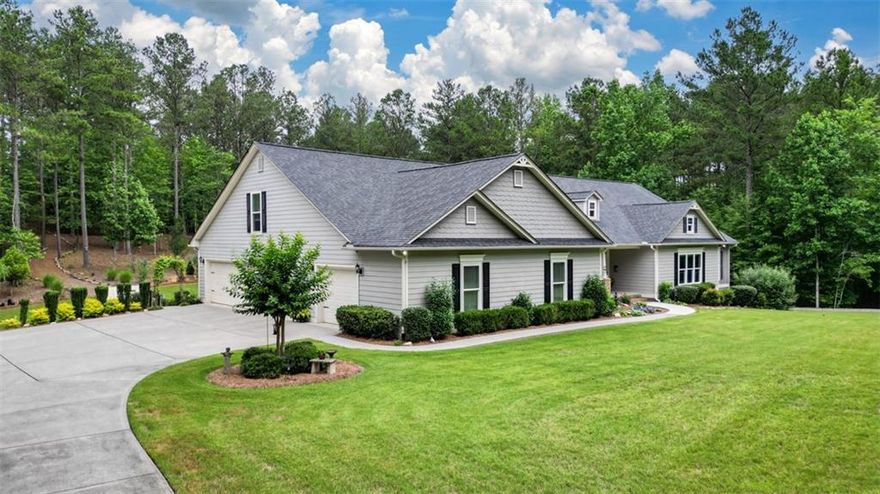 Escape to the perfect combination of tranquility, luxury, and convenience with this stunning custom retreat on over 5.3 private acres—just 1 hour from Atlanta and only 15 minutes to Lake Allatoona.
Designed for comfortable living and effortless entertaining, this spacious 4-bedroom, 3.5-bath home offers a thoughtfully crafted open floor plan with incredible attention to detail throughout. The main level features two large bedrooms, including a serene primary suite with a spa-inspired bath: double vanity, oversized jacuzzi tub, walk-in shower, and a walk-in closet. A flexible family room on the main level (currently used as a second family area) could easily convert back to an additional bedroom if desired.
The home’s inviting dining room (seats 15) and dual “see-through” brick fireplaces create a warm, welcoming space for gatherings. The gourmet farmhouse kitchen is ideal for entertaining, featuring granite countertops, a large center island, a stylish backsplash, modern appliances, and an expansive 9x11 butler’s pantry with abundant storage.
The light-filled living room, anchored by triple windows, offers panoramic views of the beautifully landscaped yard and private wooded backdrop. Upstairs, you’ll find two additional bedrooms, a full bath, and a large, flexible family/playroom with convenient walk-in access to three oversized attic areas providing exceptional storage.
Step outside to an impressive 19x32 covered back porch, perfect for morning coffee or evening entertaining, overlooking a professionally landscaped backyard oasis complete with a tiered saltwater pool and waterfall. Enjoy daily wildlife sightings, including turkey and deer, from the privacy of your own retreat.
Additional highlights include:
• Oversized 4-car garage, with one bay converted to a woodworking shop and a 50 amp service line for electric vehicle charging.
• Detached 20x40 barn, matching the home’s exterior, ideal for RV/boat storage or workshop use
• Private walking & ATV trails throughout the property
• Picturesque creek along rear property line
• Energy-efficient construction with 3 HVAC units
• Owned 1,000-gallon buried propane tank
• Private well with purification system & septic
• Full-height crawl space for easy access & additional storage
• No restrictions — bring your RV, boat, and toys!
Outdoor recreation abounds—enjoy fishing or kayaking just 1/4 mile away, or launch your boat from Lake Allatoona public ramp only 15 minutes from the property.
Bonus opportunity: The adjacent 5.3-acre lot (186 Macedonia Rd, $240K) is also available—perc-tested and ready to build. Perfect for multi-generational living, a future custom home, or an investment.
This one-of-a-kind estate offers instant equity (recently appraised at $1,085,000) and the ultimate combination of privacy, convenience, outdoor lifestyle, and luxurious living—ready for you to call home.