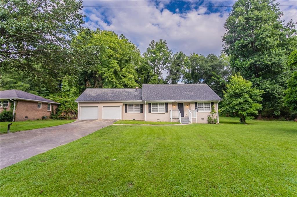 Welcome to this charming 3-bedroom, 2-bathroom home that blends comfort and style. The inviting living room features a cozy fireplace, perfect for relaxing evenings. The kitchen is equipped with stainless steel appliances, crisp white cabinets, and plenty of counter space for meal prep and entertaining. Enjoy your mornings or unwind in the evenings on the screened back porch overlooking the backyard. A spacious 2-car garage adds convenience and storage. One or more photos have been virtually staged. Schedule a showing today!
