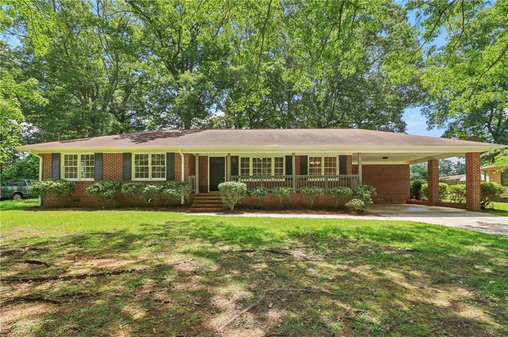 Stunning, all brick ranch home with beautiful updates throughout! This 3-bedroom, 2 full bath home has awesome curb appeal. Very classic brick exterior with covered front porch, and spacious attached carport. Walk inside to a very clean, modern, yet approachable interior. Renovated kitchen features new cabinets, counter tops, fixtures, and appliances that are included. New flooring, paint, light fixtures everywhere else. Two full bathrooms with updates. Walk out back to a large screened in porch, and oversize rear deck to enjoy a very nice backyard. In said backyard included a massive storage building that has many uses. Storage, workshop, vehicle housing, gym, and much more. Great location just minutes to highways, and downtown Griffin.