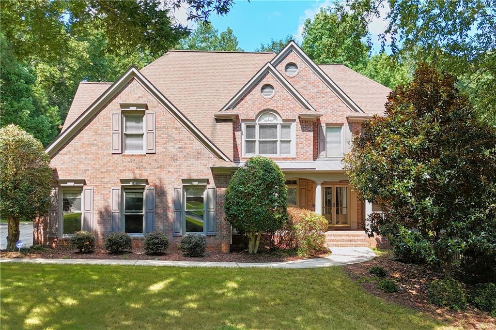 Immaculate home on a rare 1.57-acre lot with a 3-car garage, located on one of the most desirable streets in Grand Cascades!
This property welcomes you with a charming front porch and a bright family room featuring a wall of windows that frame views of the private, wooded backyard. The main level includes a full guest suite, while the beautifully finished terrace level offers another complete in-law suite with its own kitchen, spacious living area, and plenty of room for entertaining. Upstairs, the oversized primary suite comes with a bonus room for added flexibility, and the home also features a large laundry room and a workshop on the terrace level.
Step outside to enjoy the flagstone patio, firepit area, and the expansive natural setting perfect for outdoor gatherings. Located in the highly sought-after Lambert High School district, this home also provides access to Grand Cascades’ amazing amenities: Jr. Olympic pool, kiddie pool, lighted tennis courts with pavilions, sports fields, playground, 2 stocked lakes for fishing or kayaking, and miles of scenic trails along the Chattahoochee River.