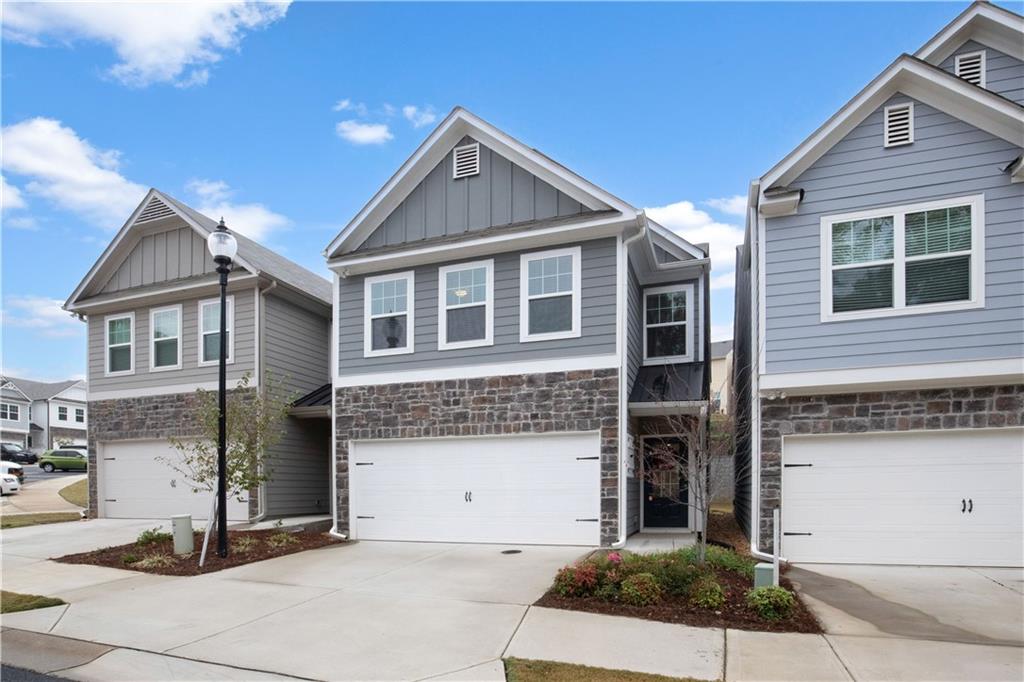 Make luxury your own in this beautiful, modern, single family home! Built in 2021, it still feels like new - only one prior tenant. Open concept floorplan with a huge kitchen island just in time for the holidays! Stainless and white, all electric, luxury vinyl plank floors, recessed lights, windowed closet and a patio out back to relax and grill. Washer-dryer and lawn care included to meet your every need. Relaxed owner management is open to a longer lease and small dogs or cats under 20 pounds. Wonderful, woodsy, and quiet community near Cherokee Aquatic Center, Alpine Bakery, the outlet mall, and downtown Woodstock!