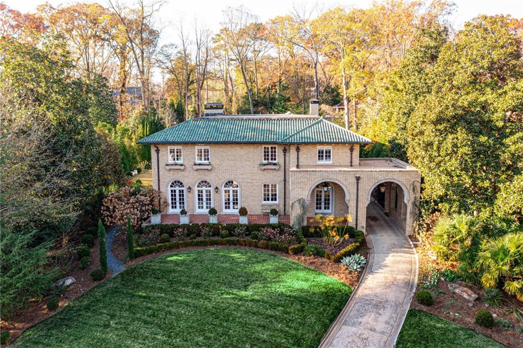 PRICE ADJUSTMENT! This 1919 Italianate home, featuring grand common spaces, exquisite architectural detailing, impressive staircase, sun filled solarium, 5 fireplaces and manicured estate grounds, is truly one of Druid Hills very finest homes.  Add to that a seamless addition that includes cooks kitchen w high end cabinetry and appliances, marble counters and multiple work and pantry spaces overlooking family room, separate primary bedroom/bath wing w generous lanai overlooking the heated salt water pool plus four additional bedrooms with en suite baths and an open sitting room, finished lower level w grotto-style wine cellar w tasting room and bar, work out room, media room, "pool table room" and half bath, professionally landscaped acre plus grounds w gorgeous pool, multiple seating areas, pickle ball/ sports court and fire pit, separate building for home office, pool house or au pair suite, 3 car garage plus plenty of off street parking for guests, all make this one of a kind home a "must see."