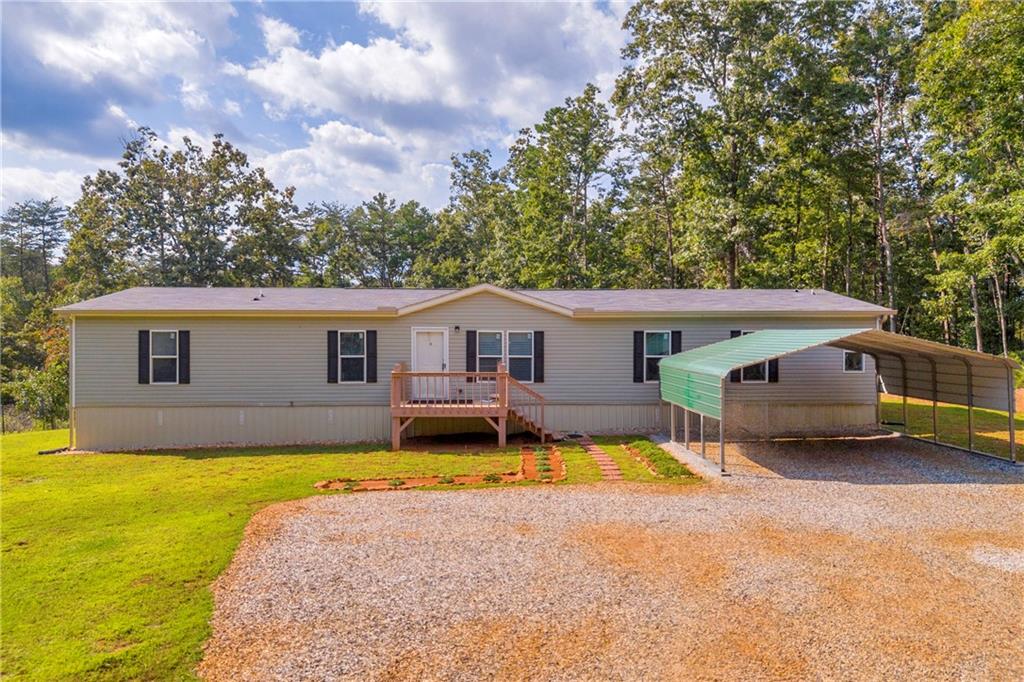 Discover this spacious 2,300 sq. ft. home in Murrayville, offering 6 bedrooms and 3 bathrooms on 3 private acres with NO HOA! The open floor plan is highlighted by LVP flooring throughout, a large dining room, and a stunning kitchen featuring a massive island with wine storage, built-in plug-ins for cooking, ample counter space, stainless steel appliances, and a huge walk-in pantry with an additional kitchen closet. The oversized master suite includes a walk-in closet, soaking tub, double vanity, walk-in shower with a built-in seat, and an extra-large linen closet. With a total of 7 closets throughout, storage will never be an issue. The mudroom, complete with its own outdoor entrance, provides plenty of space and functionality for everyday living. Step outside to enjoy a beautifully maintained garden and five outbuildings, including workshops and two fully equipped tiny homes with electricity and living quarters—perfect for guests, hobbies, or additional income opportunities. Located near local wineries and family adventures, this property truly has it all—space, versatility, and charm!