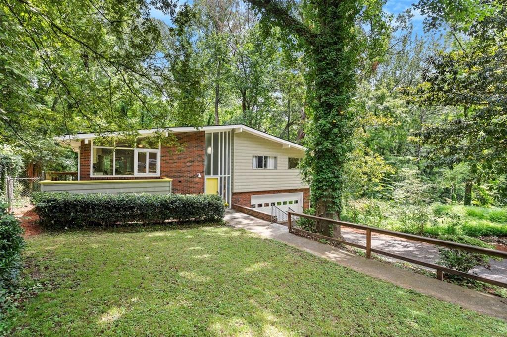 A mid-century modern forest enclave in the heart of Atlanta — where timeless design meets total restoration and unmatched privacy.
Tucked into the trees in historic Collier Heights, this fully restored 3-bed, 3-bath gem blends vintage soul with modern peace of mind. The 2019 renovation brought all-new electrical, plumbing, insulation, and HVAC, while the 2023 roof, 2021 sewer line, and brand-new 2025 garage door mean the big-ticket items are already done. Inside, a huge chef’s kitchen opens to sun-drenched living spaces with gleaming original hardwoods and sleek, upscale fixtures.
The vibe? Effortlessly cool. The layout? Perfect for entertaining — especially the finished basement built for game nights, movie marathons, or impromptu cocktail hours. Add in a rare 2-car garage, ultra-private lot, and the low taxes of Collier Heights, and you've got a one-of-a-kind in-town retreat that feels worlds away.