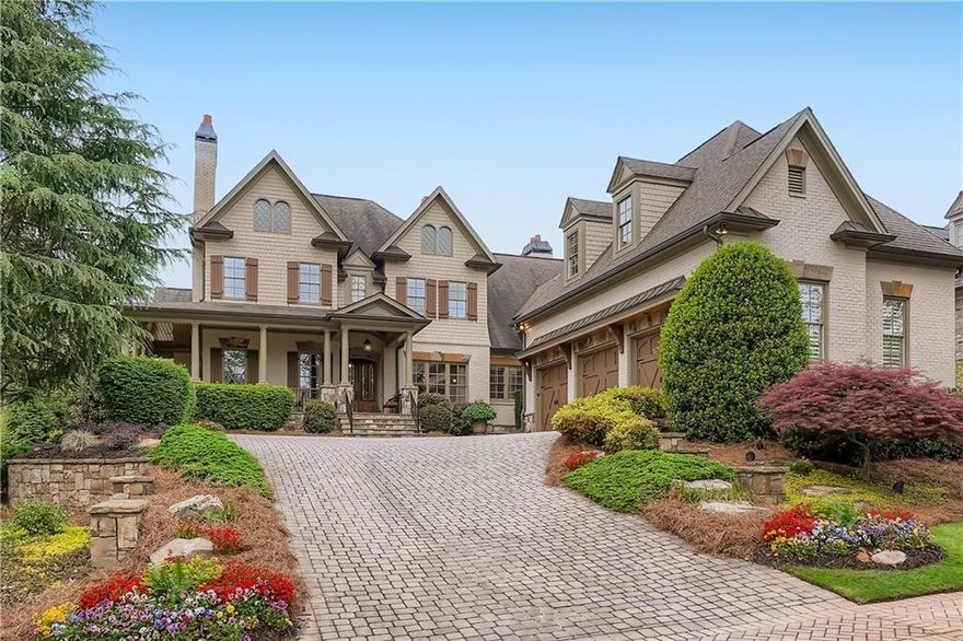 Exquisitely perched on a premier corner lot, this exceptional painted brick and stone traditional craftsman commands a presence in one of East Cobb’s most exclusive enclaves of homes.  The wrap around porch welcomes you into a stately foyer with exquisite triple crown molding and 12 foot ceilings.  The wood paneled study features a fireplace, coffered ceilings, and built-in storage.  The dining room seats 12+ guests and features exquisite millwork on the ceilings and walls.  Bathed in light, the living room with coffered ceiling and custom stone fireplace opens to the deck overlooking the pool.  Built for entertaining, the chef's kitchen features Wolf and Sub-Zero appliances and opens to a dramatic keeping room with beamed tongue and groove cathedral ceiling and cozy fireplace.  The spacious master on the main suite features triple tray ceilings and stunning bath with free standing copper tub, marble flooring, dual vanities, dual water closets, and two enormous walk-in closets.  Upstairs are four large en suite secondary bedrooms, two with attached living space that would be perfect for an office or playroom.  The expansive, walk out terrace level is the ultimate fun zone with bar, game room and living room that opens to the exceptional hardscaped patio and pool.  The terrace level also includes a playroom, exercise room, bedroom and full bath.  The backyard oasis will delight with heated salt water gunite pool, complete with waterfall and spa, outdoor kitchen and lush landscaping.  HOA provides landscaping and yard maintenance. A private well supplies water for the pool and irrigation systems, saving hundreds of dollars a month. This phenomenal home is located in the award-winning Mount Bethel/Dickerson/Walton school districts.