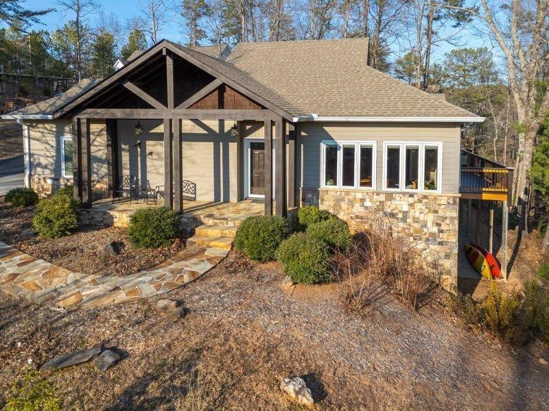 Surpassing your expectations from the ground up! You are sure to realize the hidden potential of this unique home. It's YOUR turn to appreciate the many special features of this impressive 4 BR 2.5 bath residence. Unbelievable price of less than $159.50 Per Heated Square Foot for this home with top-of-the-line construction. These owners put their heart and soul into designing and building this custom home using highly efficient Polysteel Construction (Polysteel goes up from basement level to ceiling level of the main floor) providing superior insulation, sturdy thick walls complemented with Hardie Plank exterior siding. Exceptional Pella Casement Windows and Pella Doors have integrated blinds. Enjoy a beautiful view of Yonah Mountain right from the stone front porch, living room or from the spacious wooden deck that includes a screened in porch accessed from the deck or the French doors from the primary bedroom. The living room features a stacked stone gas log fireplace. A separate dining room has hardwood floors and could easily be utilized as an additional bedroom, or office. The large open kitchen has custom cabinets, tile backsplash and breakfast bar area, but add to all that, a pantry cabinet plus a pantry closet. All appliances included! This comfortable, affordable home can be a full-time residence or an investment property for Short Term Rental. Enjoy the SAFETY of this QUIET, LOW MAINTENANCE property with no opportunity for TERMITES! Need more? The well-planned terrace level has 3 generous bedrooms, 2 of which open onto the patio, a full bath, a wet bar, an office, a storage room, and a workshop! The storage room & workshop are heated & cooled; the workshop could also be finished into an additional bedroom, craft room, or rec room. The list goes on, but to name just a few more special features, we must mention the WHOLE-HOUSE TANKLESS WATER HEATER, Central Vacuum, WIDE DOORS and hallways, HVAC System with 3 Zones, mature native landscaping with blueberry bushes and many wildlife resistant plantings. ALL of this on TWO beautiful lots in the Innsbruck neighborhood, near the popular city of Helen and many other NE Georgia attractions. The two lots have been combined under the POA so you pay only one POA fee!