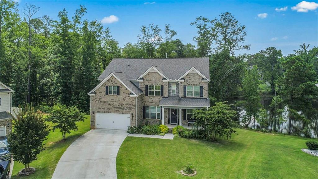 Luxury Living with Scenic Views in McDonough! Welcome home to this stunning 4-sided brick estate offering the perfect blend of elegance, comfort, and functionality-all nestled on a picturesque cul-de-sac lot with lovely pond views. Boasting 5 spacious bedrooms and 4 full bathrooms, this home is designed to impress from the moment you step inside. The expansive Owner's Suite is a true retreat, featuring a private sitting area, a spa-inspired glass shower, and a large walk-in closet. A main-level guest bedroom with a full bath offers flexible living arrangements for visitors or extended family. The heart of the home is a gourmet kitchen, complete with a large island, plenty of cabinets and stainless-steel appliances overlooking the two-story family fireside room. Just off the kitchen, step out onto the back deck overlooking the tranquil pond-ideal for morning coffee or evening relaxation. Additional highlights include; Separate living room (Office) and dining room, In-law suite upstairs with full bath and walk-in closet, Murphy bed for added convenience and space in a secondary bedroom, Whole-home water filtration system, Outdoor lighting and full irrigation system, Unfinished basement-ready to customize or finish for added living space or potential rental income. This exceptional home truly has it all-luxury finishes, thoughtful features, and peaceful surroundings. Schedule your private tour today and experience one of McDonough's finest offerings!