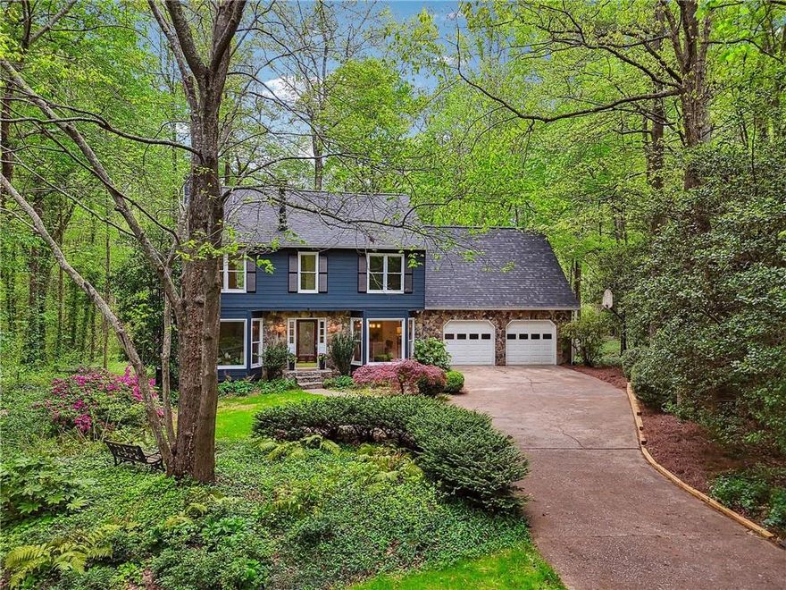 ****Buyer Incentive*****20k to use any way you want with a closing by July 15, 2025**** Storybook Charm Meets Modern Elegance in Andover North / Downtown Alpharetta Tucked away on an exceptionally rare 1.1+ acre lot, this enchanting property offers the perfect blend of privacy, nature, and convenience-all just moments from vibrant Downtown Alpharetta. A long, winding driveway lined with azaleas, cherry trees, and maples welcomes you home, setting a picturesque tone that feels like something out of a fairytale. Inside, discover a thoughtfully updated interior featuring bleached natural hardwood floors on the main level. To the left, a light-filled office with a bay window makes working from home a pleasure. On the right, a formal dining room-also with bay windows-offers an elegant space for entertaining. At the heart of the home is a cozy stone fireside family room with built-ins and recessed lighting, seamlessly connected to the stunning, fully renovated eat-in kitchen. Designed with the home chef in mind, it features custom white cabinetry with built-in spice racks and pull-outs, a spacious pantry, gleaming quartz countertops, and high-end stainless appliances-including a gas range, microwave drawer, French door refrigerator, dishwasher, and sleek vent hood. Through charming French doors, you'll find a sun-drenched four-seasons room with vaulted ceilings, skylights, and panoramic views of the private backyard oasis. Venture out onto the oversized low deck-ideal for grilling, entertaining, or simply enjoying the serene surroundings, complete with a babbling creek and quaint footbridge. The main level also includes a stylish half bath, a mudroom hallway, and a vaulted flex space-perfect as a second office, studio, or rec room. Upstairs, the primary retreat is a sanctuary of its own, featuring hardwood floors, a cozy fireplace, a custom walk-in closet, and a spa-inspired ensuite bath with dual quartz-topped vanities, a soaking tub, a large walk-in shower with frameless glass, and skylights that fill the space with natural light. Three additional spacious bedrooms share a large hall bath, and the upstairs laundry room with sink adds everyday convenience. Additional highlights include: New architectural roof, Three HVAC zones and two newer furnaces, double-pane windows, oversized two-car garage plus extra parking pad, community pool and playground located just across the street. This is more than just a home-it's a rare gem where comfort, beauty, and lifestyle come together in perfect harmony.