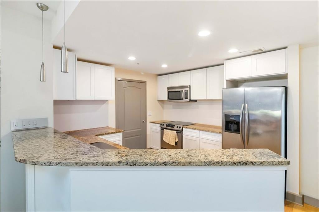 Experience stunning Atlanta skyline views from this gorgeous condo! This 4th-floor unit is ideally situated in one of the best locations within the building, offering both convenience and privacy. Enjoy secure, easy access from the gated parking garage with controlled entry. The spacious kitchen features granite countertops, stainless steel appliances, and a breakfast bar that opens to a bright, airy living room with floor-to-ceiling windows and captivating city views. The primary suite includes private balcony access, a generous walk-in closet, and a large en-suite bathroom with a soaking tub, separate shower, and double vanity. Washer and dryer are included, along with two deeded parking spaces and a private storage unit, adding exceptional value and convenience. Community amenities include a resort-style pool, fitness center, car wash station, gated parking, club house and dog park. Just a short stroll to top-tier shopping, dining, and entertainment — this one is truly a must-see!