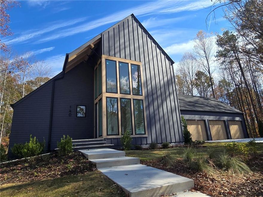 4,142 Finished Sq Ft Next Level Modern Home with Amazing Curb Appeal on 1.3 Acre Homesite.  Finished Basement with Full Bath and one Unfinished Room for Storage. Pricing includes curated design upgrades.  Move In Ready for December, be home for the holidays! Guest suite located on the main level with a work from home space.  The Vaulted Primary Suite is upstairs with a Large Laundry with Lower Cabinets and 2 other bedrooms with private en suites.   This is a perfect homesite for a pool. Large Andersen casement windows offer lots of light that showcase the natural beauty of the trees and surroundings.  The architectural details on the exterior and interior of this home have been meticulously thought out and planned.   A delicate balance of light and dark materials, mixed with warm stained woods and timeless metal finishes, create a traditional feel to the interior, while still being fresh and modern to complement the exterior design of the home. The kitchen features Bell Cabinets with soft close drawers and doors and a 54" smooth plastered chimney hood, and Thermador appliances to include a 48" Range.  The pantry has custom shelving.  Expand your living outdoors to the 18’ x 12’ rear covered porch off the kitchen with 12' Slider Doors! The family room has casement Andersen windows with amazing views to the outside and boasts a 42" direct vent gas fireplace. The secondary bathrooms are incredible with metal framed mirrors, designer lighting and trim details.  Hardwoods are included throughout the home.  A finished terrace with full bath completes this home.  This home is a Zero Energy Ready Home, Spray Foam Insulation in the Attic envelope of the entire home and exterior walls, 18 Seer HVAC and Tankless Water Heater.   Aster features an amenity area with fire pit, activity lawn, unstructured play area and nature trails throughout the community.  Roswell is Named One of the Top Three Cities in the Nation to Raise Your Family, released by Frommer's.   USE 845 COX ROAD ROSWELL  as GPS