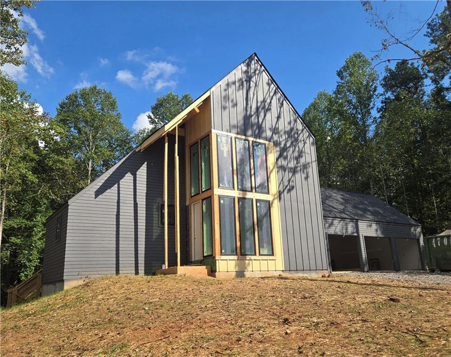 4,142 Finished Sq Ft Next Level Modern Home with Amazing Curb Appeal on 1.3 Acre Homesite.  We are Sheetrocked and about to Mud, Sand and Paint  Finished Basement with Full Bath and one Unfinished Room for Storage. Pricing includes curated design upgrades.  Estimated late 4th Quarter 2025 Move in. Guest suite located on the main level with a work from home space.  The Vaulted Primary Suite is upstairs with a Large Laundry with Lower Cabinets and 2 other bedrooms with private en suites.   This is a perfect homesite for a pool. Large Andersen casement windows offer lots of light that showcase the natural beauty of the trees and surroundings.  The architectural details on the exterior and interior of this home have been meticulously thought out and planned.   A delicate balance of light and dark materials, mixed with warm stained woods and timeless metal finishes, create a traditional feel to the interior, while still being fresh and modern to complement the exterior design of the home. The kitchen features Bell Cabinets with soft close drawers and doors and a 54" smooth plastered chimney hood, and Thermador appliances to include a 48" Range.  The pantry has custom shelving.  Expand your living outdoors to the 18’ x 12’ rear covered porch off the kitchen with 12' Slider Doors! The family room has casement Andersen windows with amazing views to the outside and boasts a 42" direct vent gas fireplace. The secondary bathrooms are incredible with metal framed mirrors, designer lighting and trim details.  Hardwoods are included throughout the home.  A finished terrace with full bath completes this home.  This home is a Zero Energy Ready Home, Spray Foam Insulation in the Attic envelope of the entire home and exterior walls, 18 Seer HVAC and Tankless Water Heater.   Aster features an amenity area with fire pit, activity lawn, unstructured play area and nature trails throughout the community.  Roswell is Named One of the Top Three Cities in the Nation to Raise Your Family, released by Frommer's.   USE 845 COX ROAD ROSWELL  as GPS