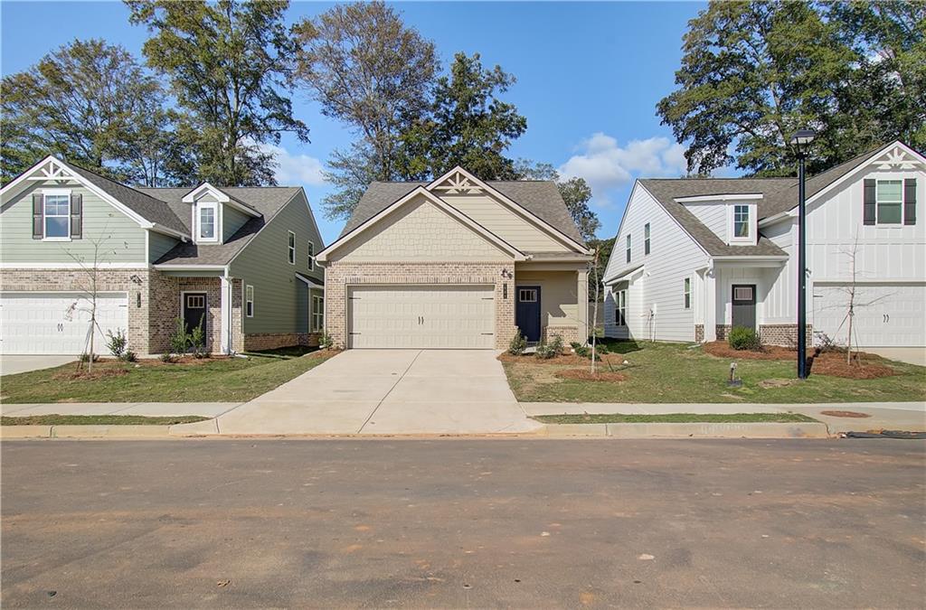 Welcome home to the EMMA at Towne Center on Lot 178, located in the highly sought-after Hampton community by DRB Homes! This exquisite single-family home showcases a stunning Craftsman exterior that enhances its curb appeal and welcomes you in with warmth and style.
Spanning a generous layout, the EMMA plan features 3 bedrooms and 2.5 bathrooms, all thoughtfully designed for modern living. The main level boasts an open-concept design, perfect for entertaining and everyday family life. The spacious family room flows effortlessly into the kitchen, creating an inviting atmosphere.
The kitchen is truly a highlight of this home, featuring an expansive island with luxurious quartz countertops, providing ample space for meal prep and casual dining. Beautiful cabinetry adds both style and functionality, while the generous walk-in pantry ensures that all your culinary essentials are within easy reach.
Conveniently located on the main level, the owner's suite serves as a tranquil retreat. This thoughtfully designed space offers both privacy and comfort, with an en-suite bathroom featuring modern fixtures and ample storage.
As you head upstairs, you'll discover a large loft area, perfect for a home office, playroom, or additional living space. Two sizable secondary bedrooms each come with walk-in closets, providing plenty of room for family members or guests.
Please note that the photos may not represent the actual home, but they give a glimpse into the quality and design you can expect. Don’t miss out on this opportunity to make the EMMA your new home in the vibrant Hampton community!
Please note: If the buyer is represented by a broker/agent, DRB REQUIRES the buyer’s broker/agent to be present during the initial meeting with DRB’s sales personnel to ensure proper representation. If buyer’s broker/agent is not present at initial meeting DRB Group Georgia reserves the right to reduce or remove broker/agent compensation.