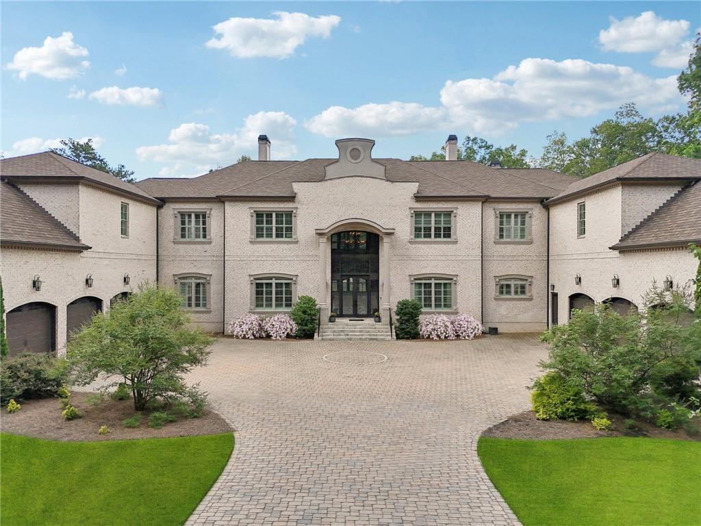 Exceptional Custom Estate on the 5th Hole of Echelon Golf Course | 7 Beds | 8 Full & 3 Half Baths | Approx. 17,000 Sq Ft
Welcome to a masterpiece of design and craftsmanship in the gated golf community of Echelon. Perfectly situated on the 5th hole, this one-of-a-kind estate offers a lifestyle of privacy, elegance, and resort-style amenities.
Every detail in this home has been thoughtfully curated from the soaring ceilings to the intricate architectural elements found in each room. No two ceilings are the same, with custom designs that elevate the home’s aesthetic and create a sense of grandeur in every space.
The main level boasts expansive living and dining areas, a stunning chef’s kitchen with premium appliances, and a catering kitchen/scullery with walk-in pantry for seamless entertaining. All seven bedrooms are private retreats, each with its own en-suite bath and walk-in closet. The luxurious primary suite features a spa-like bath, oversized custom closet, and a private covered terrace with a fireplace and serene golf course views.
The terrace level is a destination of its own, designed for entertaining and relaxation. Highlights include a state-of-the-art GolfZON golf simulator, home theater, sports bar, pool table area, sauna, steam room, and a quiet guest suite with private access to the pool.
Step outside to your resort-style oasis featuring a saltwater pool with waterfall features, fire bowls, a Baja sun shelf, and a fully equipped outdoor kitchen and grilling area all overlooking the fairway.
Additional features include: elevator access to all three levels, multiple laundry rooms, his and hers garages with parking for six vehicles, whole-home generator, Integrated smart systems for lighting, climate, sound, and security.
This is more than a home, it’s an experience. With unmatched attention to detail, an ideal golf course location, and proximity to top-rated schools, fine dining, and amenities, this is truly one of North Atlanta’s most extraordinary offerings.
Echelon is an exclusive golf community home to one of Georgia’s top-rated courses designed by Rees Jones. Spanning 600 acres of picturesque rolling hills, Echelon features a premier 32-acre practice facility and offers breathtaking views throughout. Ideally situated near Avalon, Halcyon, Vickery, Crabapple, Downtown Roswell, Hwy 9, and GA 400—this location blends privacy with convenience. Benefit from Cherokee County taxes.