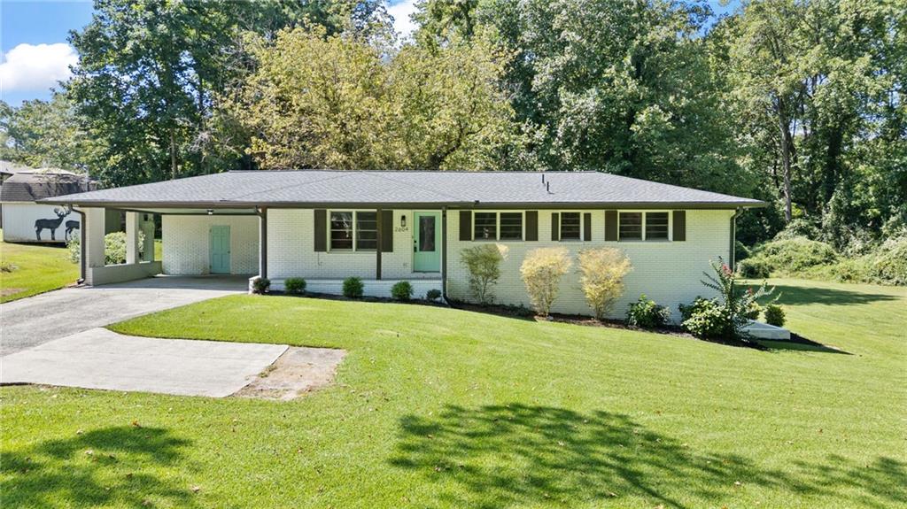 Gorgeous ranch home with fully finished basement and stylish updates inside & out! Charming curb appeal with painted door, matching carport, and front porch. Spacious open-concept main level featuring refinished original hardwood floors, a beautiful kitchen with granite counters, floating shelves, pantry, and oversized island with bar seating for guests. French doors open to a large back porch—perfect for entertaining with a quiet view! The primary suite includes a private full bath with walk-in shower. Two additional bedrooms on main with an updated hall bath and tiled tub/shower combo.
Terrace level offers even more living space with hardwood floors, game room/workout room/office, whatever TWO rooms you can dream up! There is an updated full bath with double vanity. Check out the working kitchen! Backyard is absolutely stunning with lush grass, shady oak trees, and exterior entrance from the terrace level. Major systems including HVACs, water heater, furnace, electrical, and plumbing were all updated within the last few years for peace of mind.
This home has it all—fresh finishes, two kitchens, multiple living areas, and an entertainer’s backyard—every inch has been thoughtfully cared for!