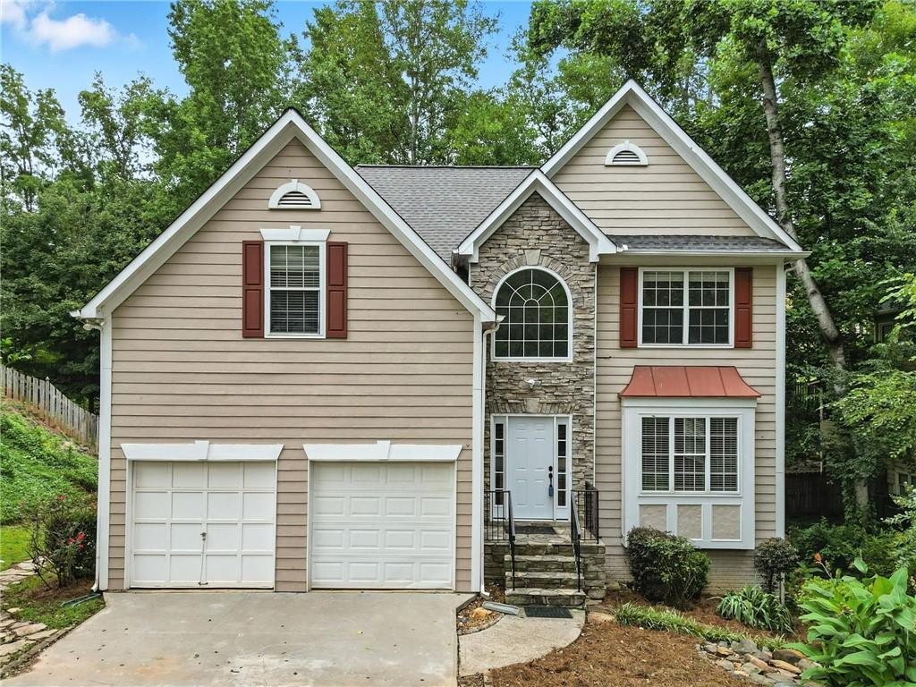 Great value in Towne Lake's Wyngate subdivision for a home with a full basement that already has a finished bath! This 4-bedroom, 3.5-bath home offers a spacious fenced backyard and a basement suite with full bath ready for finishing touches—just add flooring and a mini split. Features include a living/dining combo, separate family room, updated kitchen with white cabinets, granite counters, breakfast area, new range, and new sliders to the deck. The upstairs master suite has a large walk-in closet, double vanity, and separate tub and shower. Three more bedrooms, one with built-ins, and a full bath. Enjoy the large backyard with firepit, patio, deck, and lots of room to play. Wyngate offers 2 pools, active swim team, clubhouse, tennis, basketball, pickleball, playground, sidewalks, and active social activities. Convenient to Woodstock Downtown, Lake Allatoona, and all the shops and restaurants in Towne Lake.