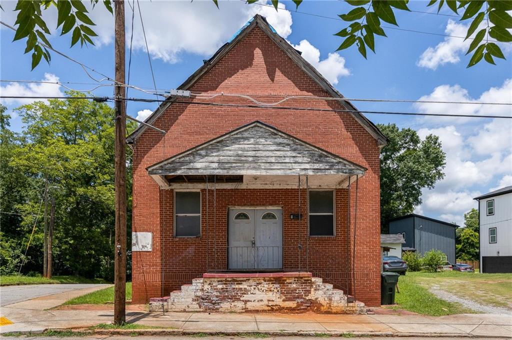 Double corner 6800 sf residential R4 lot perfect for a gut renovation or your next flip. This former church has a full basement and tall pitched ceilings that would be perfect for a easy single-family house that allows for an ADU or additional residence in the adjoining grass lot. Price includes both the church and lot. Raise main floor to have basement in-law suite as well. If you want your next project to be 0.3 miles to the Beltline and a few blocks to new developments and food halls, this is the one for you. Southside Beltline to be paved by World Cup June 2026! Owner can share plans for a 4 br/3 ba floor plan and possible in-law suite basement or create or live your own renovation dreams perfect for investment, primary residence, rental, Airbnbs, or combination of all!