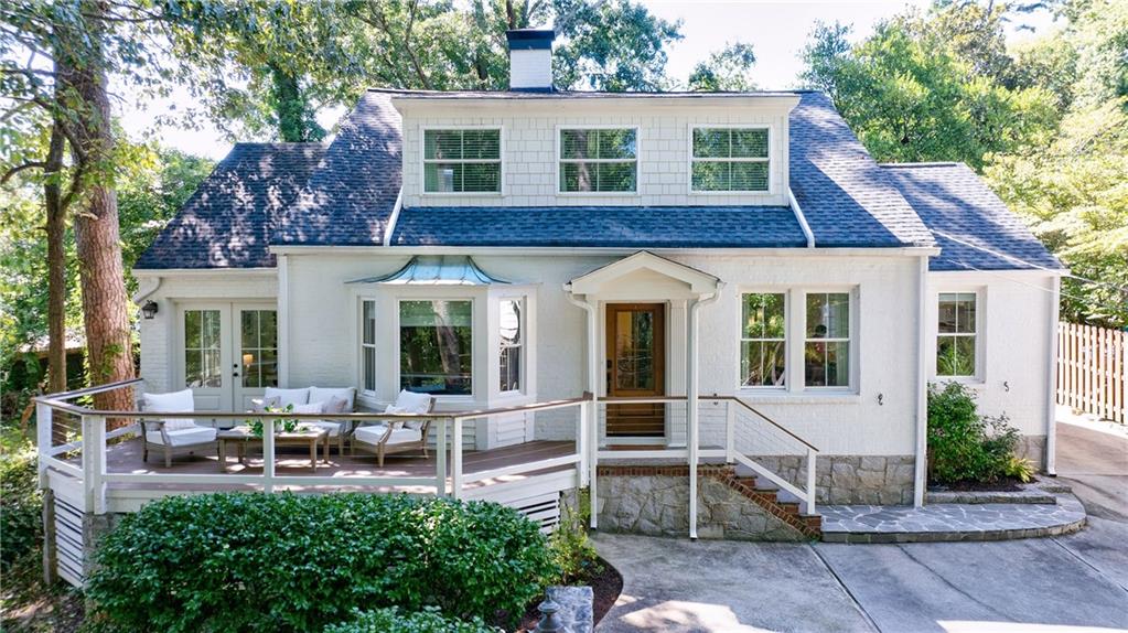 This Renovated home in sought after Garden Hills in Buckhead is done to perfection! This open floor plan is perfect for today's living with the fireside family room with a bay window that opens to the dining room & kitchen. This exceptional custom kitchen with honed Carrara marble counters, to the ceiling Zellige tile backsplash, floating wooden shelves and an eat up island with Circa pendants seats three. Top of the line appliances are sure to please including a new six burner Blue Star Range, a panel front refrigerator/freezer, two under counter dual zoned wine refrigerators, pantry with pull-out shelves plus a door to the level backyard patio and yard. The office on this level features French doors that open to the front deck, skylights and built-in shelving. The primary suite is on the main level with a large walk-in custom closet, renovated bathroom with a dual vanity with quartzite counters, a separate free standing soaking tub and a large walk-in shower with accent tile and dual shower heads. There is another bedroom on the main level with a renovated hall bath with a tub/shower combination. The main level also features a laundry room with built-in cabinets The light filled upstairs center hall features skylights and a cathedral ceiling. Three large bedrooms are on this upper level one with its own ensuite bath, dual vanity and walk-in closet. A second laundry room is also on this level. From the kitchen walk out to the perfectly manicured yard and patio, making outdoor entertaining and relaxing an everyday affair. Smell the yellow roses that are in full bloom while grilling off the patio and dining alfresco. The low maintenance front yard features specimen azaleas. Truly one-of-a-kind home in a one-of-a-kind neighborhood which offers a pool, playground, 4 parks, and the ability to walk to neighborhood restaurants, shops, local schools and The Farmer's market on Saturday.