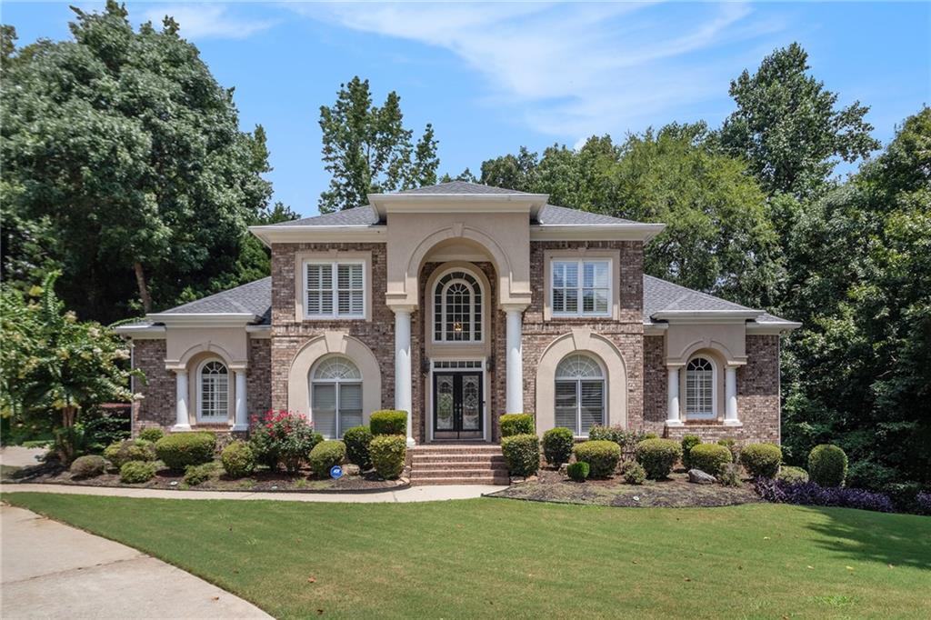 Stately three-sided brick home on a full finished basement, ideally situated in a quiet cul-de-sac. The property features a spacious three-car side-entry garage and a well-designed floor plan offering both functionality and elegance. Inside, you'll find a private office, a formal dining room, and an eat-in kitchen with solid surface countertops—perfect for everyday living and entertaining. The main-level primary suite includes two walk-in closets and a luxurious en-suite bathroom with dual vanities, a separate shower, and a whirlpool tub. Upstairs, there are three additional generously sized bedrooms. The fully finished basement adds even more living space with a second kitchen, a dining area, a cozy bonus room with an electric fireplace, an additional bedroom, a full bathroom, and multiple flex rooms ideal for a home gym, media room, or guest space. Enjoy outdoor living with a spacious deck and patio—perfect for relaxing or hosting gatherings.