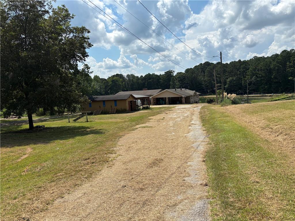 13+ acres - Lakefront opportunity!!! This spacious 5-bedroom, 3-bath home sits directly on the water, offering peaceful views and endless potential. With a little TLC, this property could be transformed into a stunning primary residence, a rental investment, or a profitable flip. The flexible floorplan and large lot provide plenty of options for updates and customization. Conveniently located near schools, shopping, and major highways.. Don’t miss your chance to invest in lakefront living—schedule your showing today!