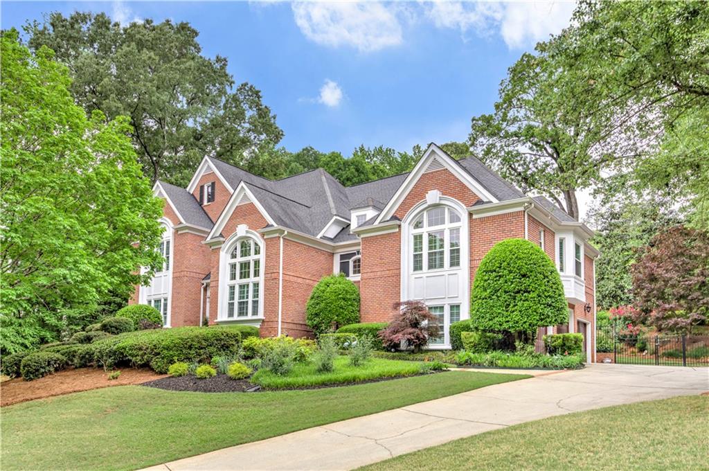 5 Bedrooms/4.5 Baths with over 6000 sq ft of living space nestled on just over 3/4 acres in the prestigious Giverny neighborhood of East Cobb, this stunning home is a true gem that offers both elegance and comfort. Just a short stroll from the serene Sope Creek Park, the location off Paper Mill Rd is ideal for those who cherish nature and tranquility. As you step into the grand foyer, the high ceilings and rich dark hardwood floors immediately set the tone for sophistication. The expansive great room is bathed in natural light, thanks to a wall of windows that frame the breathtakingly landscaped backyard, creating a perfect backdrop for gatherings or quiet evenings at home. The heart of the home is undoubtedly the newly renovated kitchen, designed to inspire culinary creativity. With its bright, white cabinetry, state-of-the-art Bosch appliances, luxurious quartzite countertops, and a generous island, this kitchen is both functional and beautiful. The owner's suite offers a private retreat, complete with his and her closets, a cozy fireplace, and a sitting area that invites relaxation. The exquisite custom marble bathroom elevates the experience, making you feel like royalty. On the upper level, you will find three spacious secondary bedrooms accompanied by two well-appointed bathrooms, ensuring ample space for family and guests. The finished terrace level adds even more charm, featuring updated paint and flooring, along with a convenient kitchen that overlooks a welcoming family space. This home is truly a perfect blend of modern design and timeless elegance.
Property boasts exterior access from the basement leading directly to a charming brick patio, perfect for hosting gatherings or enjoying quiet evenings under the stars. The backyard is a true oasis, featuring a cozy firepit, and ample space for a pool, creating an environment that encourages relaxation and fun. Breathtaking views of the moon illuminates the entire property, providing a magical backdrop for your evenings. Home also showcases a spacious 3-car garage and an enormous formal dining area, ideal for entertaining or creating cherished family memories. Located in a highly-rated school district, with Sope Creek Elementary and Wheeler High School, known for its advanced studies in STEM, this home is perfect for families seeking an exceptional educational environment. Minutes to Merchant's Walk & the Avenues @ East Cobb. Close to Historic Roswell, Marietta Square and Battery!
Gorgeous curb appeal and landscaping. Backyard ideal for outdoor parties. Fully fenced yard. New windows just installed. High end kitchen appliances and bathroom fixtures. Brand new water heaters recently replaced. Backyard Pool plan design available. In ground trampoline with drainage. Separate entrance for terrace level. Tesla charger in garage.