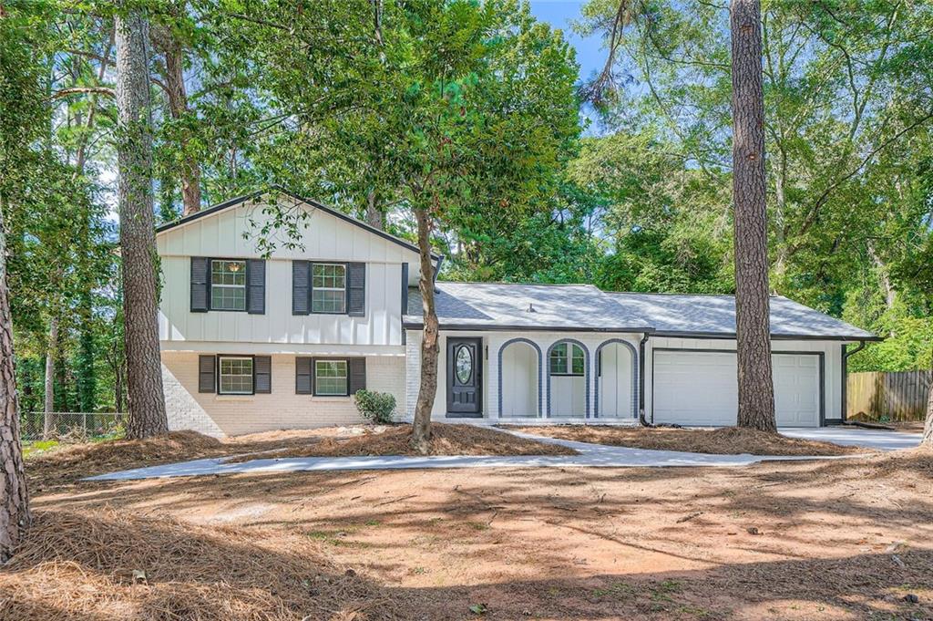 Welcome to 4666 Cedar Ridge Trail, a beautifully updated split-level home offering 4 bedrooms, 2 bathrooms, and stylish upgrades throughout. Nestled on a quiet street in a well-established Stone Mountain neighborhood, this home combines space, comfort, and modern living just minutes from Stone Mountain Park, shopping, dining, and major highways. Step inside to a bright and open main level featuring brand-new flooring, fresh interior paint, and large updated windows that fill the space with natural light. The living room flows seamlessly into the dining area and renovated kitchen, complete with new stainless steel appliances, updated cabinetry, and a generous workspace, ideal for both daily living and entertaining. Upstairs, you'll find three spacious bedrooms and a fully remodeled bathroom with modern fixtures and tile work. The lower level includes a fourth bedroom and a second fully updated bathroom, perfect for guests or use as a second primary bedroom. The remodeled garage adds additional function and convenience. Enjoy peace of mind with a brand-new roof, new gutters, new HVAC system, updated electrical and plumbing, and all-new windows for improved energy efficiency. The spacious backyard offers wooded views and room to create your ideal outdoor space. This move-in-ready home offers the perfect combination of thoughtful updates and practical layout in one of
Stone Mountain's most accessible locations. Don't miss out, schedule your showing today!