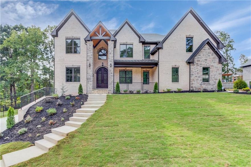 To be built, PRIVATELY GATED ESTATE • 60-INCH BUILT-IN REFRIGERATOR WITH WINE COOLER • BUILT-IN COFFEE MAKER • TWO FULL KITCHENS • OUTDOOR KITCHEN • PRIVATE GYM • SAUNA •EXTERIOR POOL BATHROOM - this extraordinary fully fenced and gated new construction estate will be perfectly positioned at the end of a quiet enclave in one of Buford’s most prestigious communities. Designed to blend timeless elegance with modern sophistication, this custom-built masterpiece will feature 6 bedrooms, 6 full bathrooms, 2 half bathrooms, and a 4-car garage, showcasing impeccable craftsmanship and luxury finishes throughout. Step through the grand 22-foot foyer into a light-filled interior with 10-foot ceilings, floor-to-ceiling windows, and exquisite architectural details. The main-level primary suite will serve as a private retreat, complete with a spa-inspired en suite bath featuring a soaking tub, oversized walk-in shower, and expansive custom closet. The chef’s kitchen will be the heart of the home, offering top-tier stainless steel appliances, a 48-inch gas range, 60-inch built-in refrigerator with wine cooler, and a built-in coffee maker. A double waterfall quartz island anchors the space, complemented by custom cabinetry, designer lighting, and premium fixtures throughout. A fully equipped secondary prep kitchen provides additional workspace, while the covered outdoor kitchen creates the perfect setting for alfresco dining overlooking a level backyard ideal for a future pool or private retreat. Additional main-level highlights include a formal dining room, private office with custom built-ins, open-concept living room with fireplace, and a dedicated gym. Upstairs, enjoy a secondary living room with fireplace and five spacious bedrooms, each with a private en suite bath. The secondary primary suite is ideal for multigenerational living or extended guests, and a second laundry room adds convenience. Located just minutes from I-85, top-rated schools, fine dining, and premier shopping, this to-be-built architectural masterpiece offers a rare opportunity to fully customize your dream home in a luxury gated Buford estate setting.