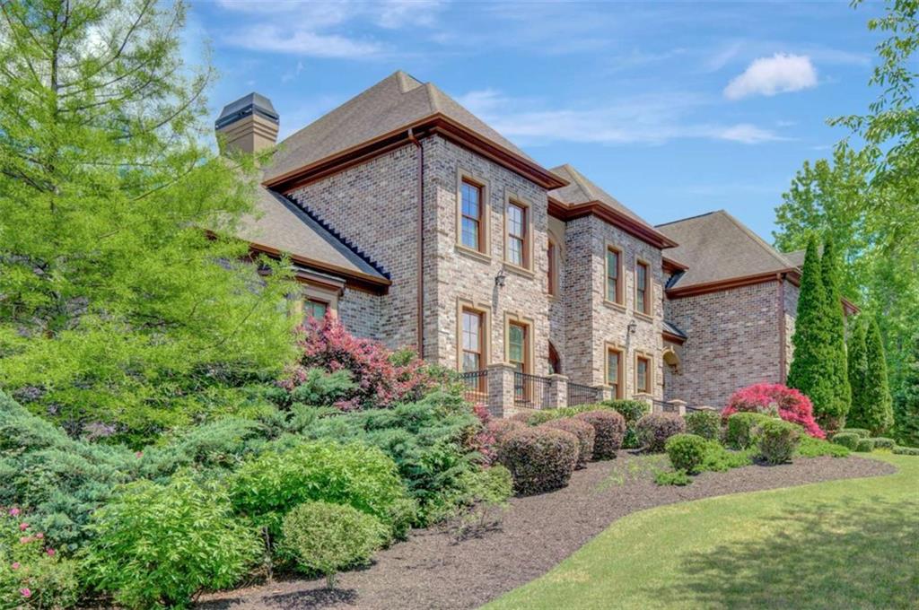 COME EXPERIENCE ESTATE LIVING IN RIVER OAKS, one of Fayette County's most prestigious communities! RECEIVE A $10K BUYER'S CREDIT AT CLOSING WITH AN OFFER ACCEPTED AND CLOSED BY 10/31/25. This four-sided brick home, situated on 2.37 acres, features a two-story foyer, a great room with expansive windows, a kitchen with keeping room, formal living and dining rooms, powder room, and a main-level owner's suite with separate bath vanities and closets. An additional guest bedroom with private bath is also located on the main floor. Upstairs includes three spacious bedrooms with en suite bathrooms, a large bonus room, and an inviting loft area. The basement offers a billiard room with wet bar, a double-sided fireplace, a comfortable living space suited for entertainment, and a fitness/flex room. Ample unfinished basement space provides opportunities for future customization and storage. The professionally landscaped yard is suitable for a swimming pool. River Oaks combines tranquil estate living with proximity to key amenities-just 2 miles from I-85, 25 minutes to downtown Atlanta, 15 minutes to Hartsfield-Jackson Airport, and close to Tyrone, Peachtree City, and the Town of Trilith. This property presents a distinguished opportunity in a prime location.
