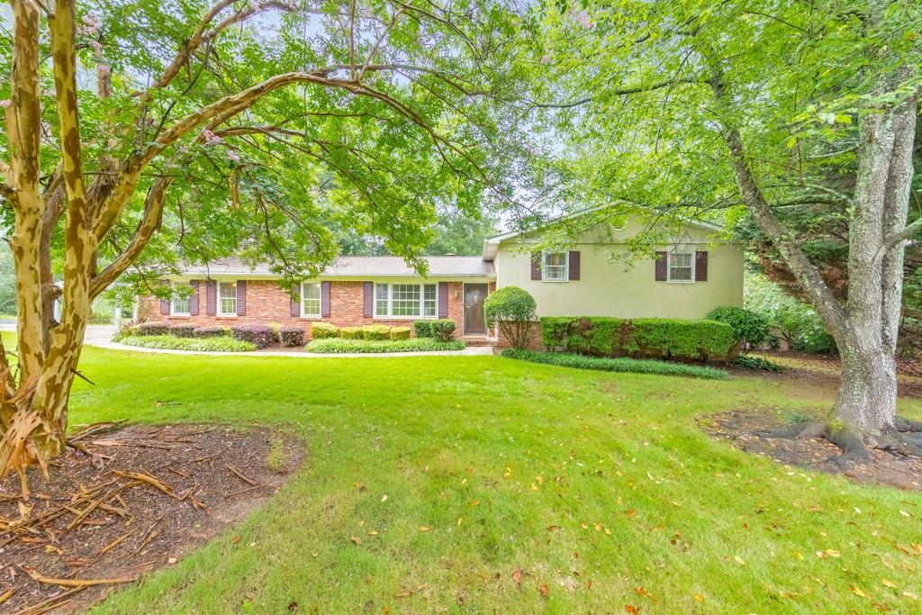 Nestled on a spacious corner lot in the Addison / Simpson / Sprayberry / Lassiter School district. This stunning updated split-level home features 4 bedrooms, 2 full bathrooms, plus a bonus room, perfect for an exercise room, home office, or additional bedroom. The layout includes a large living room with a cozy fireplace, a custom kitchen featuring a convection oven, a dining area, and a sunroom overlooking the spacious backyard. The upper level features the primary suite with a custom walk-in closet and an additional bedroom. Downstairs, there are two additional bedrooms, a bonus room, and a large laundry room. Outdoors, enjoy plenty of greenspace with a built-in sprinkler system and entertain friends and family on a custom deck, two gazebos, hot tub, and patio complete with its own tiki bar. For those needing a private office, there's finished space in the detached 1.5-car garage with its own driveway. Abundant storage options include storage buildings, a fenced outdoor storage area, and a gardening shed. Come see this unique property located near great schools, shopping, restaurants, and more!