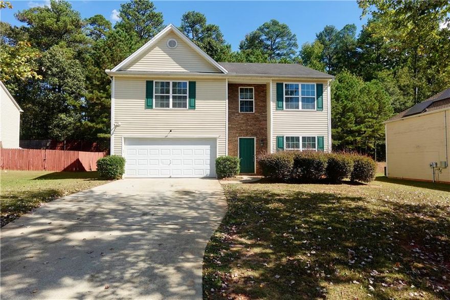 This 4-bedroom, 2.5-bath home offers nearly 2,500 square feet of comfortable living space, ideal for first-time buyers or investors seeking a property with great potential.      
You're greeted by a grand two-story foyer leading to a separate dining room that overlooks the family room with a cozy fireplace. The oversized kitchen provides ample counter space, generous storage, and easy access to the back deck, perfect for outdoor gatherings or morning coffee.      Upstairs features an intimate loft overlooking the foyer, along with spacious secondary bedrooms-each with walk-in closets. The primary suite faces the front of the home and showcases large windows, tray ceilings, and two walk-in closets, plus a separate soaking tub and shower for a true retreat experience.      
Located just minutes from Camp Creek Marketplace, Wolf Creek Amphitheater, and the Amazon Fulfillment Center, this home offers comfort, convenience, and endless opportunity to make it your own.