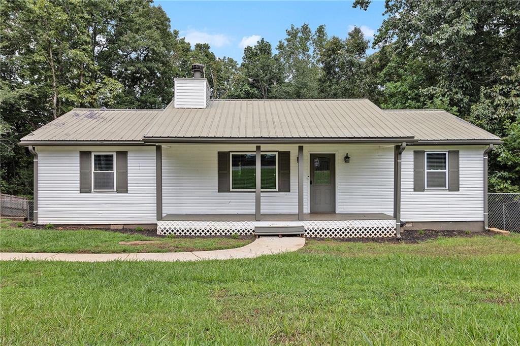*No HOA* Welcome to this 3-bedroom, 2-bath home on 1 acre in Dawsonville, GA. The living room features a cozy fireplace, recessed lighting, and Wi-Fi switches throughout. All power outlets are upgraded with USB and USB-C connections, and vinyl flooring runs throughout the home. The kitchen comes with appliances, and the master suite offers a double vanity. Enjoy outdoor living with a main-level deck and a spacious backyard surrounded by nature. It has a small unfinished basement. Plus a prime location just 5 minutes from North Georgia Premium Outlets and downtown Dawsonville. A great opportunity for first-time buyers and investors.