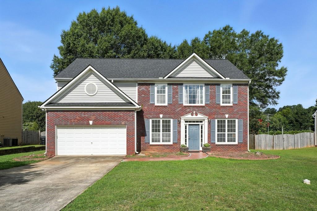 Welcome to this well-maintained brick front/vinyl-sided home featuring 4 spacious bedrooms and 2.5 bathrooms. The interior has been freshly painted and includes brand new carpet throughout. The updated kitchen offers a functional island, tile backsplash, custom soft-close cabinetry, tile flooring, high-quality appliances, and a pantry. Enjoy the warmth of the family room with a gas-log fireplace and hardwood flooring. Additional living spaces include a formal dining room, a separate living room, and a flexible office or workout room. Upstairs, a loft area provides extra space for a variety of uses. The oversized primary suite features vaulted ceilings, a large walk-in closet, and an en-suite bathroom with double vanities, a separate shower, and a garden tub. The home sits on a very level lot with a spacious, private, fenced backyard ideal for outdoor living. Move-in ready and thoughtfully updated for comfort and functionality.